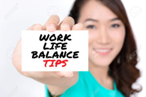 WORK LIFE BALANCE TIPS message on the card shown by a woman